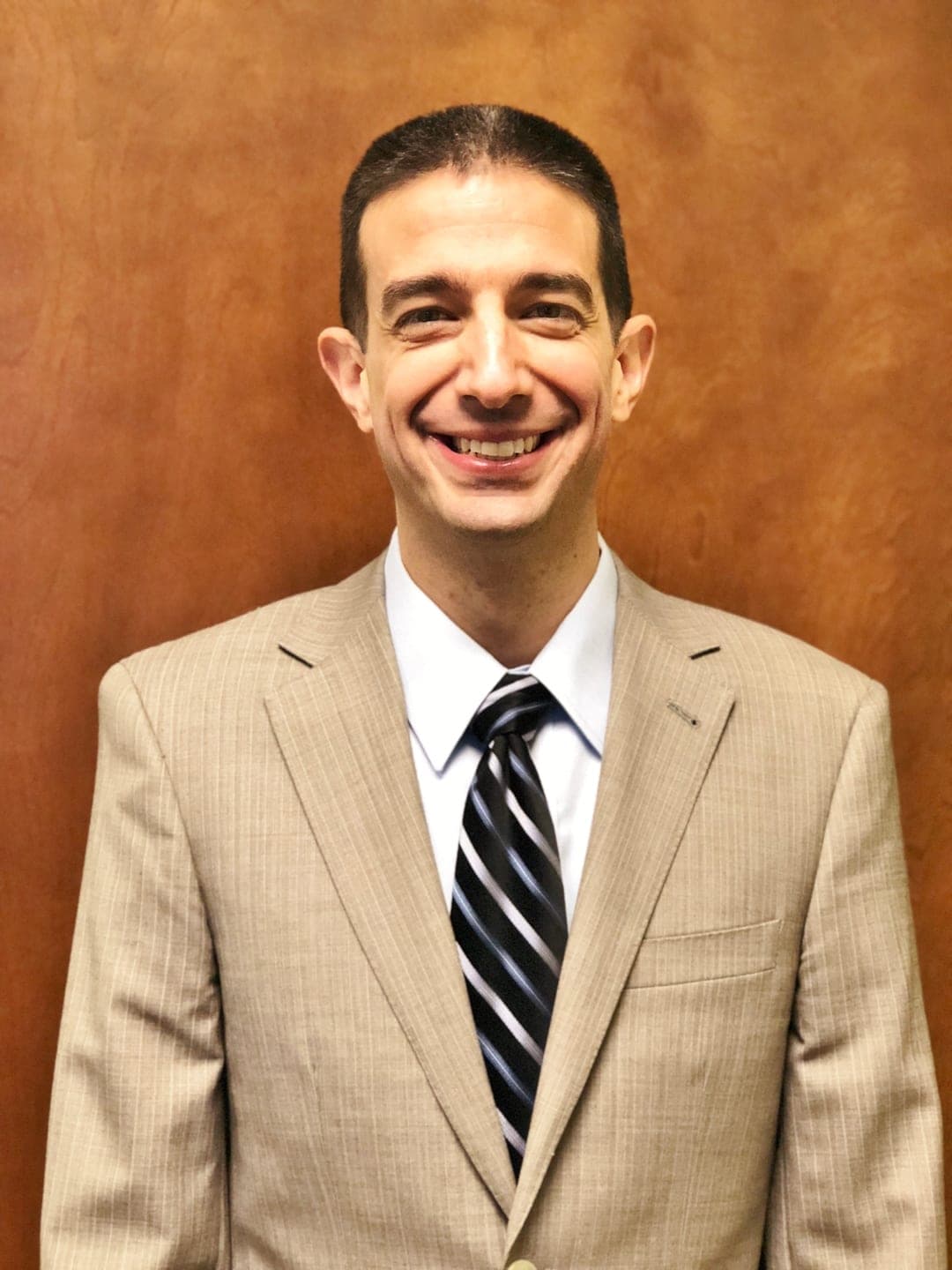 Dr. Rob DeMartino, founder of Superior Health Solutions, smiling in a tan suit